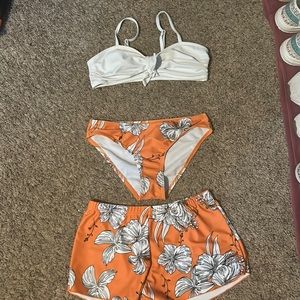 Orange swimsuit comes with shorts to put over your swimsuit bottoms/white top.
